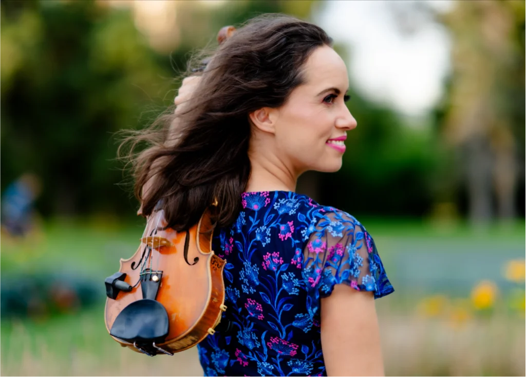 Lannie Shelton holding violin outdoors in Denver